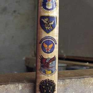Cane made for my late Father. I embellished it with insignia's of his military record.