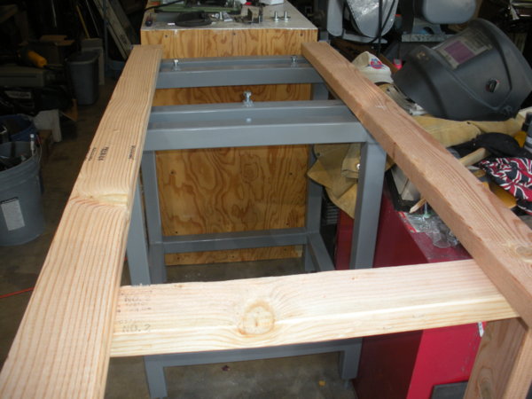 Another view of the rails on the stand. The mounting screws are turned down below the level of the sideways 2x4s